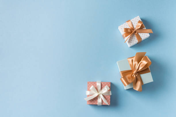 istock Gift boxes with ribbon flat lay on blue pastel background 1272667775