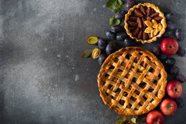 istock Autumn and summer pie with apple plum on dark  background 1272667805