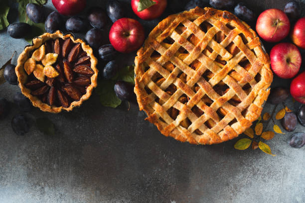 istock Autumn and summer pie with apple plum on dark  background 1272667809