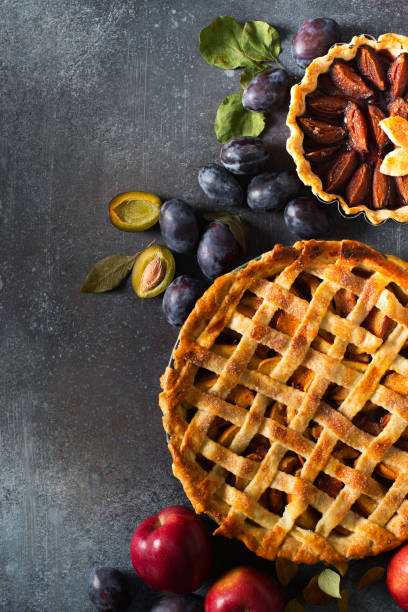 istock Autumn and summer pie with apple plum on dark  background 1272667814