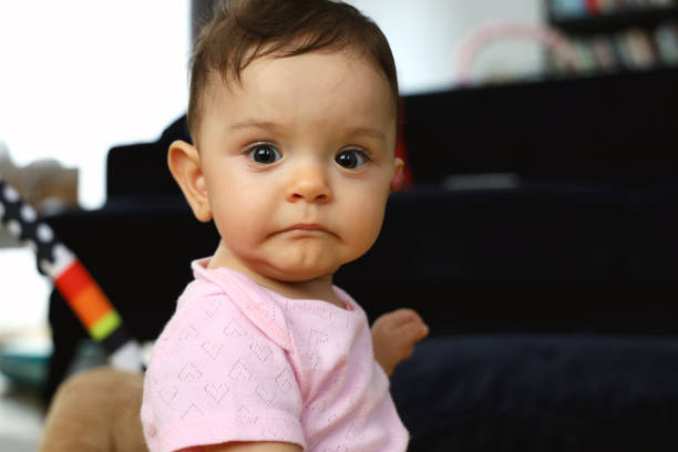 istock Bored baby girl looking at camera 1272668161