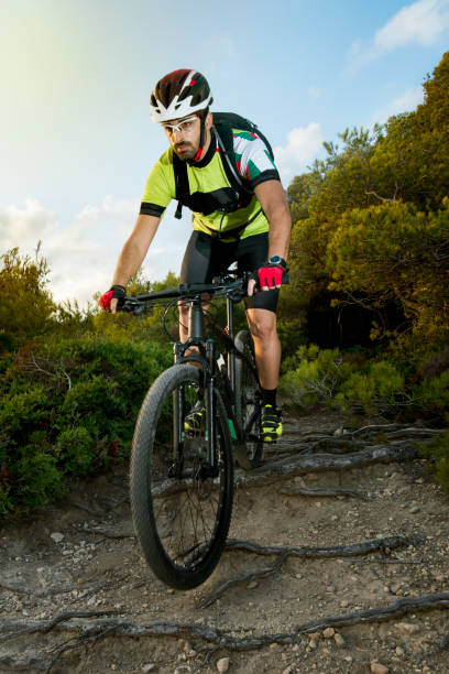 istock cyclist descends on dirt road and rocks 1272669136