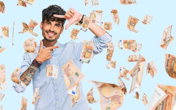 istock Young hispanic man wearing casual clothes smiling making frame with hands and fingers with happy face. creativity and photography concept. 1272669217