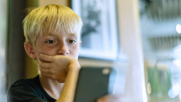 istock Bored kid with smartphone, child addicted to smartphone concept. 1272669839