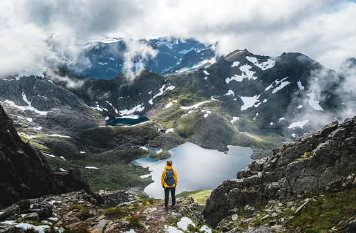 Young woman overlooking beautiful valley, Molladalen in Norway.