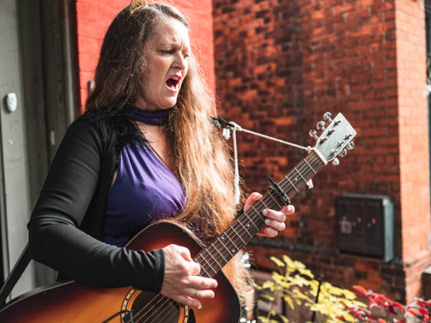 istock Woman playing acoustic guitar 1272673558