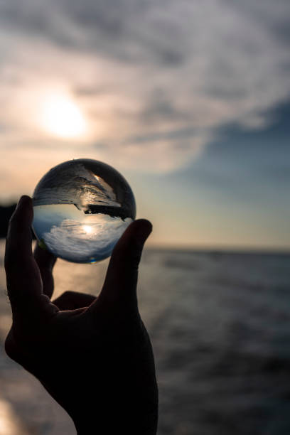 istock man's hand with crystal ball sunset sea 1272673880