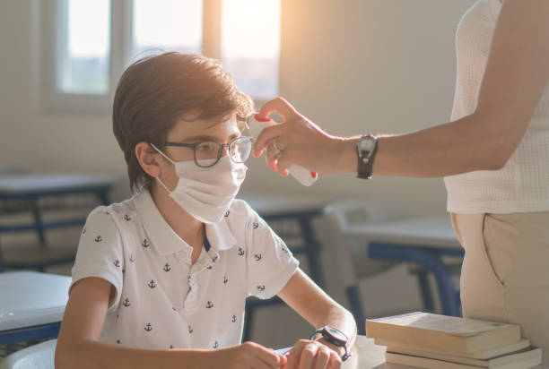 istock Temperature screening and medical check at school. 1272674243