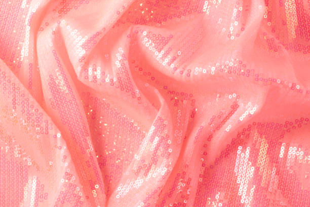 Large shiny glossy pink sequins background. Photography on the theme of the trend color 2019. Large shiny glossy orange sequins fully filling the background space. red tiger lily stock pictures, royalty-free photos & images