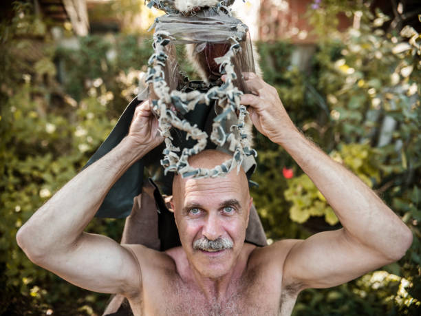 istock Senior man in garden dressed as fairy 1272676397