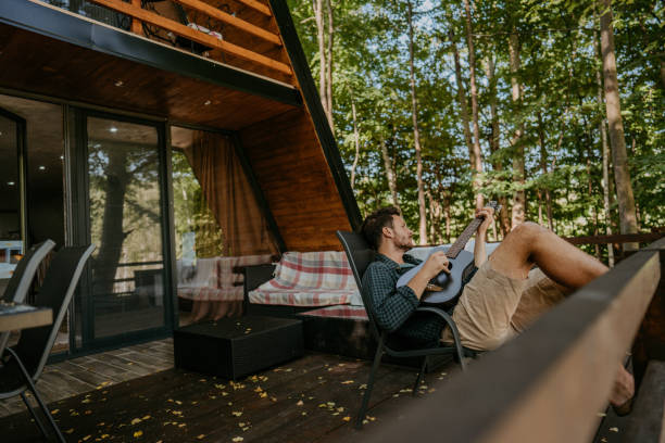 istock Man playing guitar on a balcony 1272678007