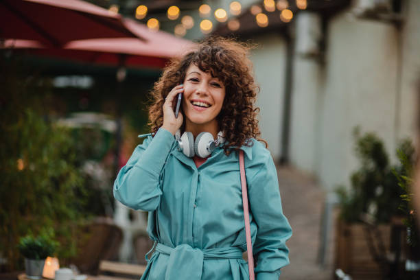 istock Happy young woman with smart phone outdoors during holidays 1272679133