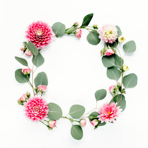 istock Round frame with pink flower buds, branches and leaves isolated on white background. lay flat, top view 1272679171