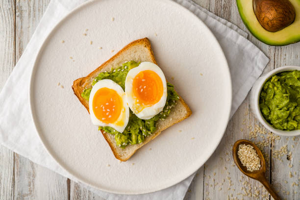istock Toast with guacamole and boiled egg, avocado toast. Top view 1272679370