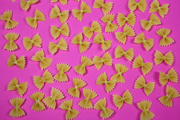 istock High angle view on isolated many farfalle noodles on pink background 1272680512