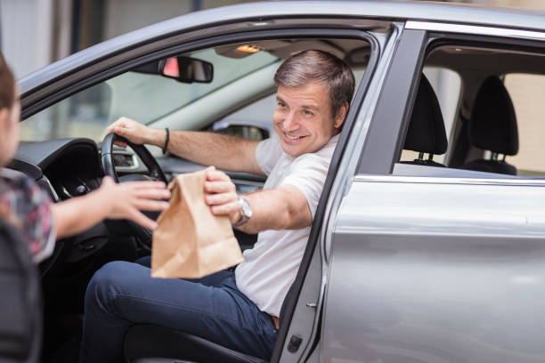 istock Happy man giving lunch box to his kid 1272681413