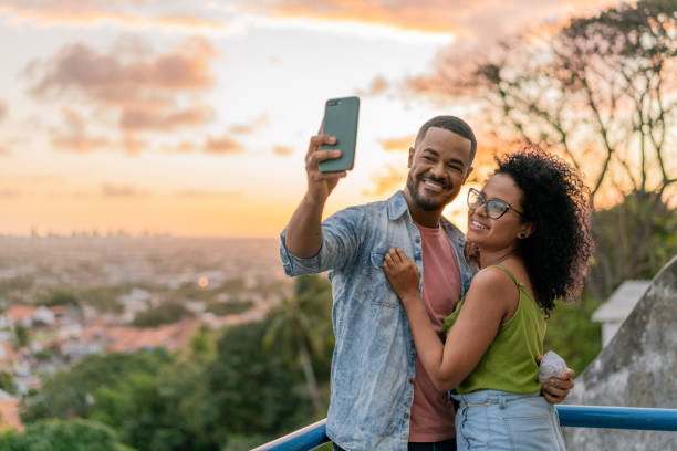 Couple taking a selfie at sunset