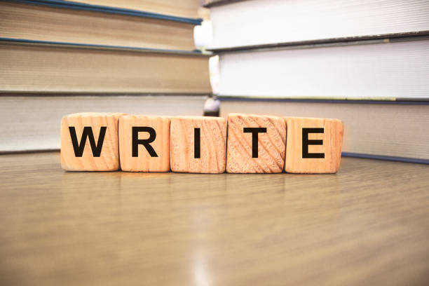 istock Write words on wooden blocks with Books on blurred backround 1272684017