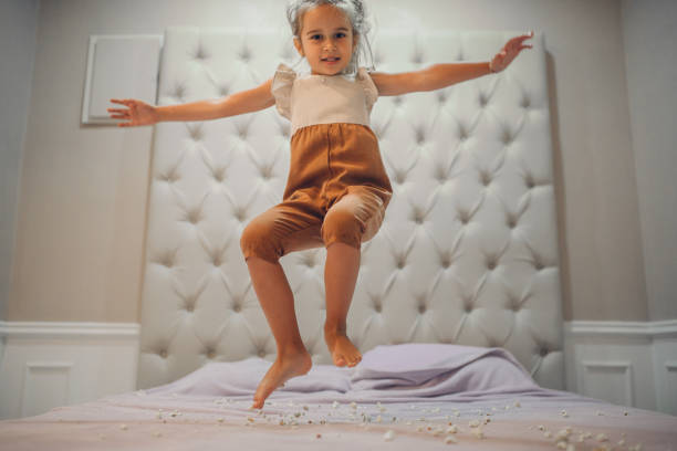 istock Happy Girl Jumping on the bed 1272684730