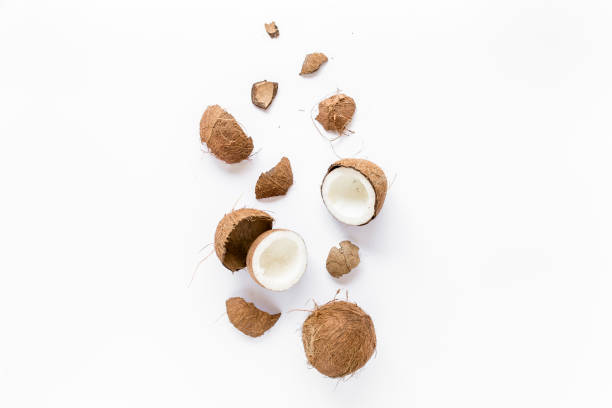 istock cracked coconut on white background. flat lat, top view 1272685737
