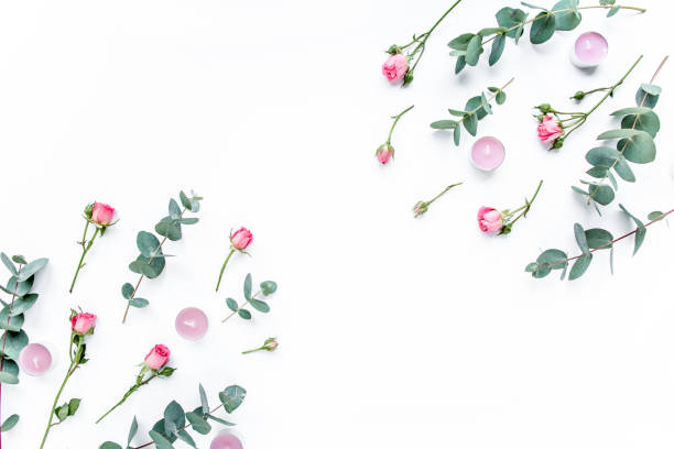 istock Floral pattern made of pink roses, green leaves eucalyptus, branches on white background. Flat lay, top view. Valentine's background. Floral pattern 1272685948