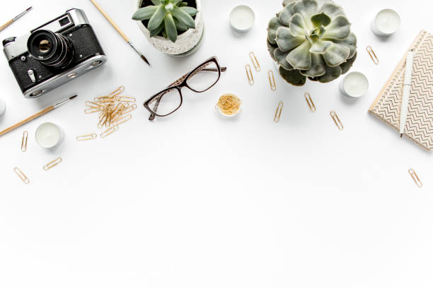 istock desk workspace with succulent, coffee, diary, glasses and golden clips on white background. flat lay, top view 1272686946