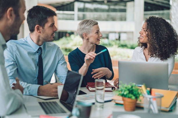 istock Group of business persons talking around the table 1272690617