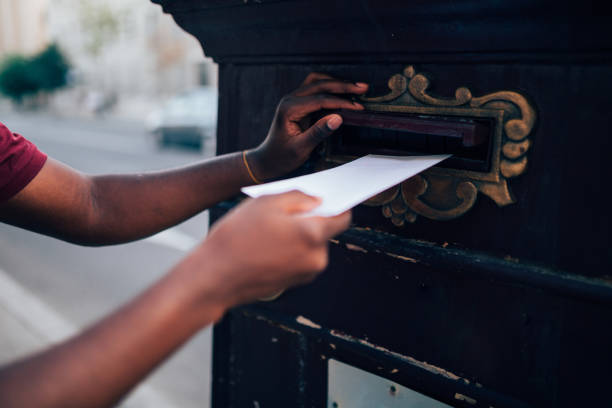 istock Young African American man voting by mail 1272691471