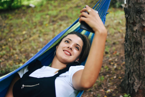istock Beautiful woman enjoying in hammock 1272693713