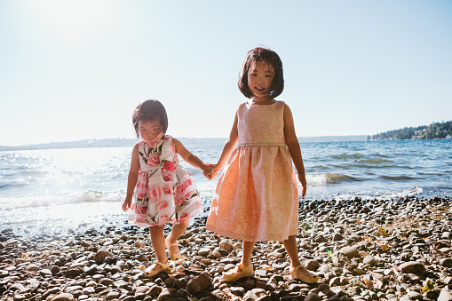Two young Korean girls spend time together on the shores of Lake Washington, in Kirkland, WA, USA.