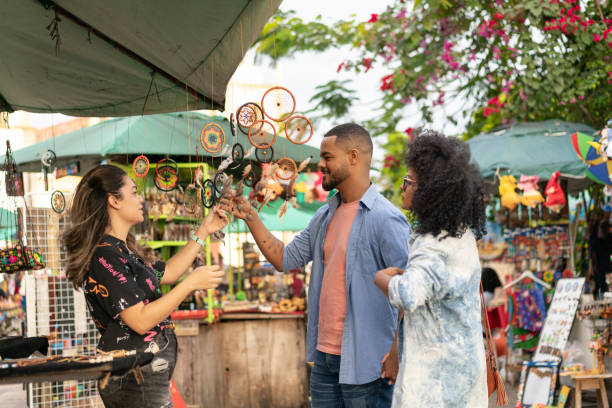 Tourist couple looking at street crafts Marketer, Multiethnic Group, Tourist, Brazil, Olinda market vendor stock pictures, royalty-free photos & images