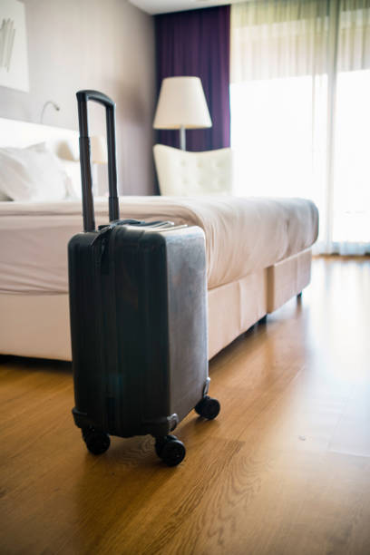 istock Face Mask and Suitcase in the Hotel Room 1272695319