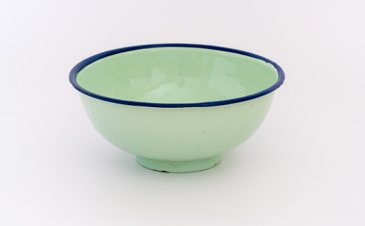 Green metal bowl on white background