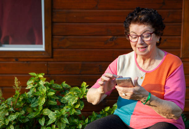 istock Happy senior woman using mobile 1272698515