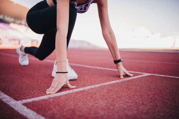 istock Athlete woman at starting line ready to run 1272699749