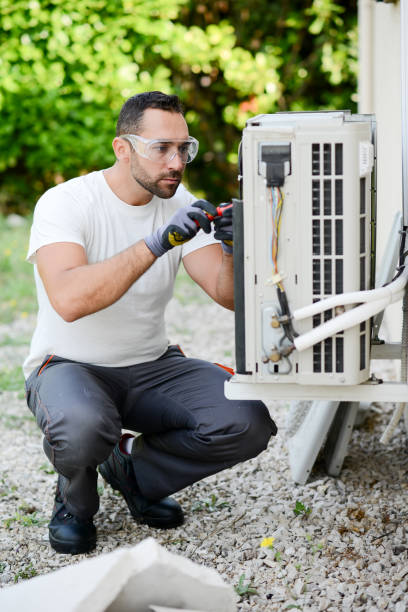 istock handsome young man electrician installing an air conditioning in a client house 1272700540