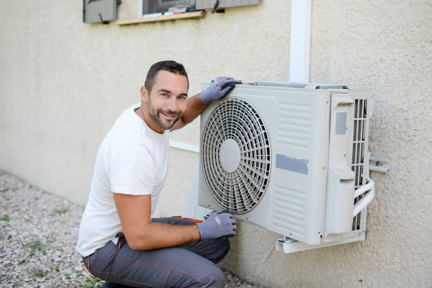 istock handsome young man electrician installing an air conditioning in a client house 1272700549
