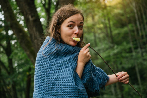 istock Young woman eating roasted marshmallows 1272702990