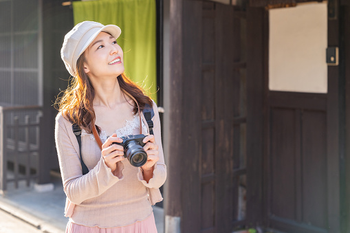 Beautiful young asian woman who travels in Kyoto,camera,Japan