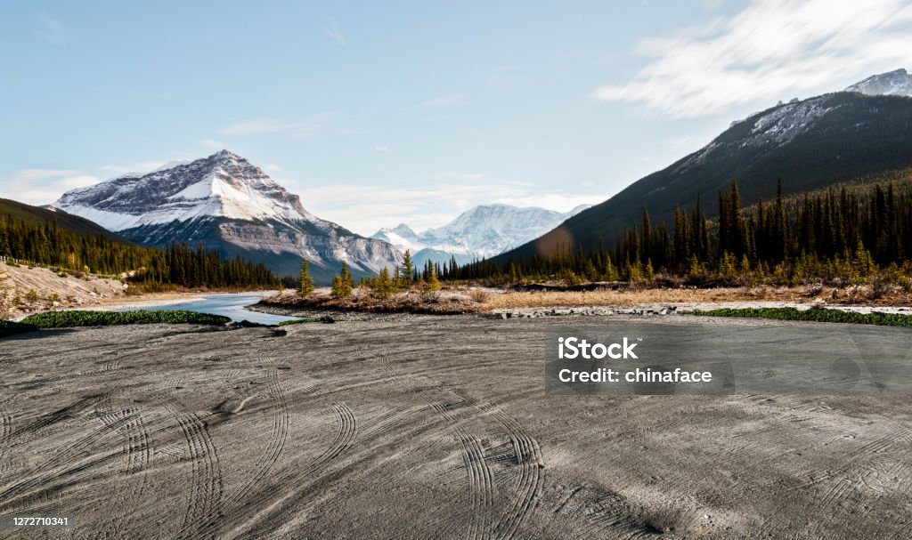 empty dirt beach with traces against Canadian Rockies empty dirt beach with traces against Canadian Rockies, AB, Canada. Backgrounds Stock Photo