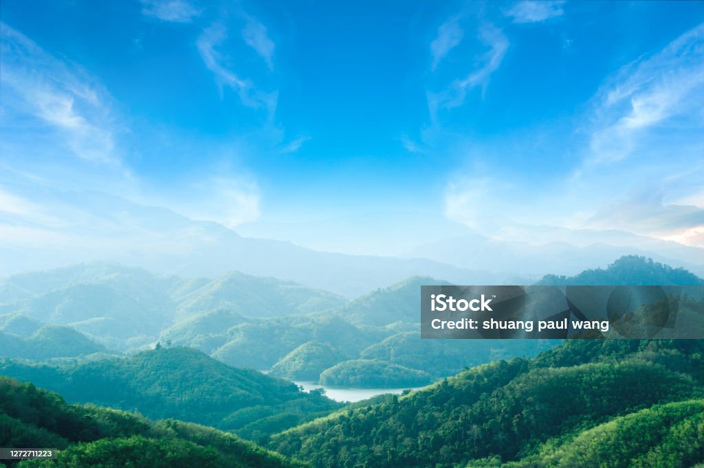 World environment day concept: Green mountains and beautiful blue sky clouds Sustainable Resources Stock Photo