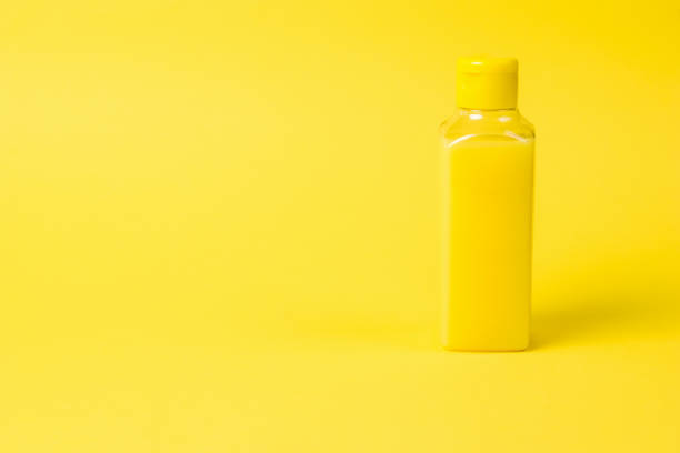 istock Plastic bottle with yellow liquid on a yellow background. 1272716123