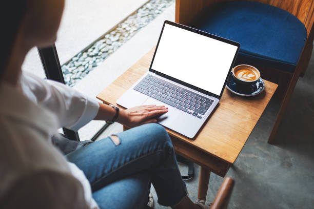 istock a woman using and touching on laptop touchpad with blank white desktop screen on wooden table 1272717970