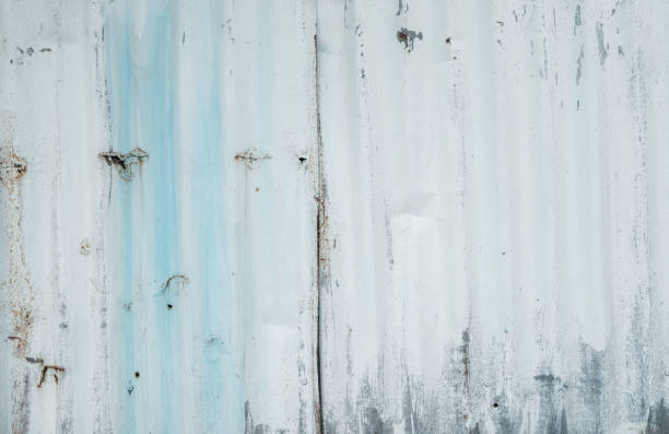 istock Galvanized sheet painted with white color. Empty white wall texture background. Peeling paint on white wall. Distorted striped gray galvanized sheet. Empty white and blue background for minimal life. 1272719798