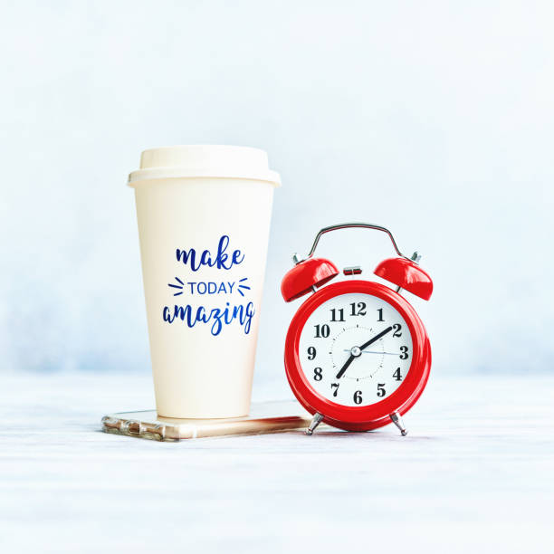 istock Make Today Amazing Coffee Cup in Bright Setting with Alarm Clock and Cell Phone 1272719937
