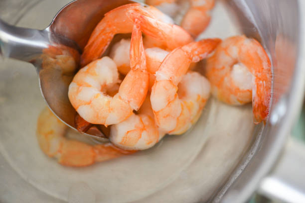 istock Boiled shrimps prawns on hot pot for cooking seafood / 1272721932