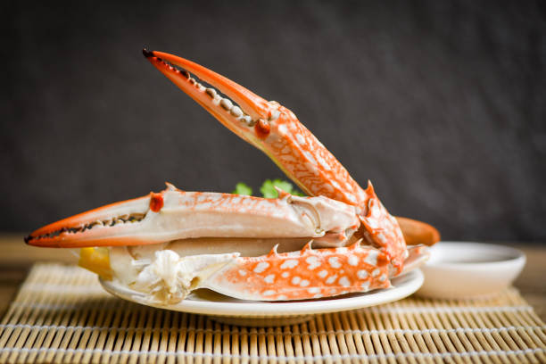 istock Boiled crab food on white plate and seafood sauce on the table - crab claws shellfish 1272721936