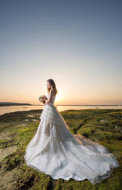 istock Bride on the beach at sunset 1272722824