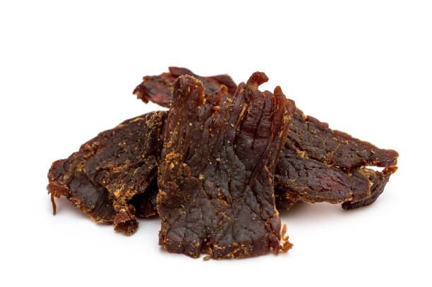 istock Heap of beef jerky on white background. 1272724907