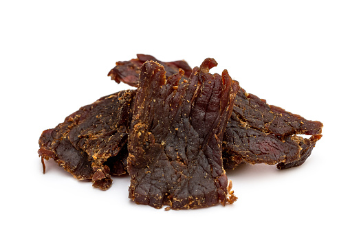 Heap of beef jerky on white background.